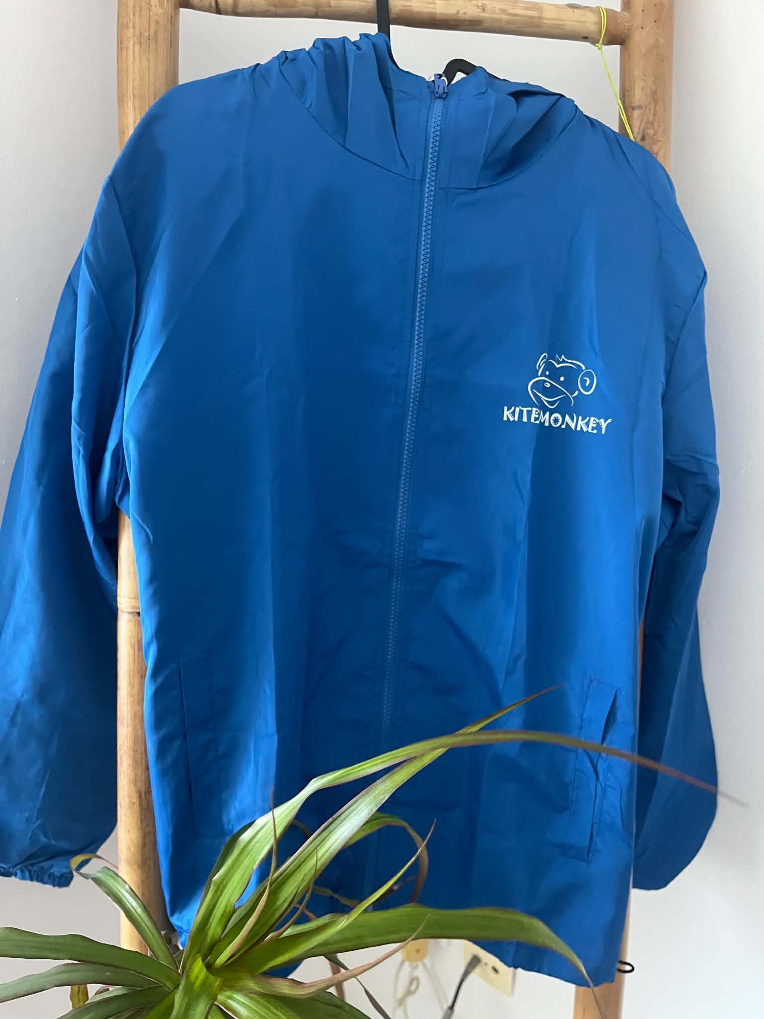 Electric blue Kitemonkey windproof jacket with hood and large kitesurf logo on the front