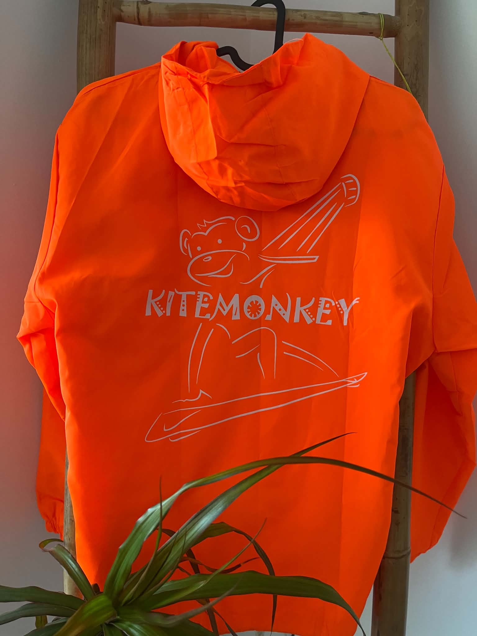 Orange Kitemonkey windproof jacket for kitesurfing, wingfoiling and watersports