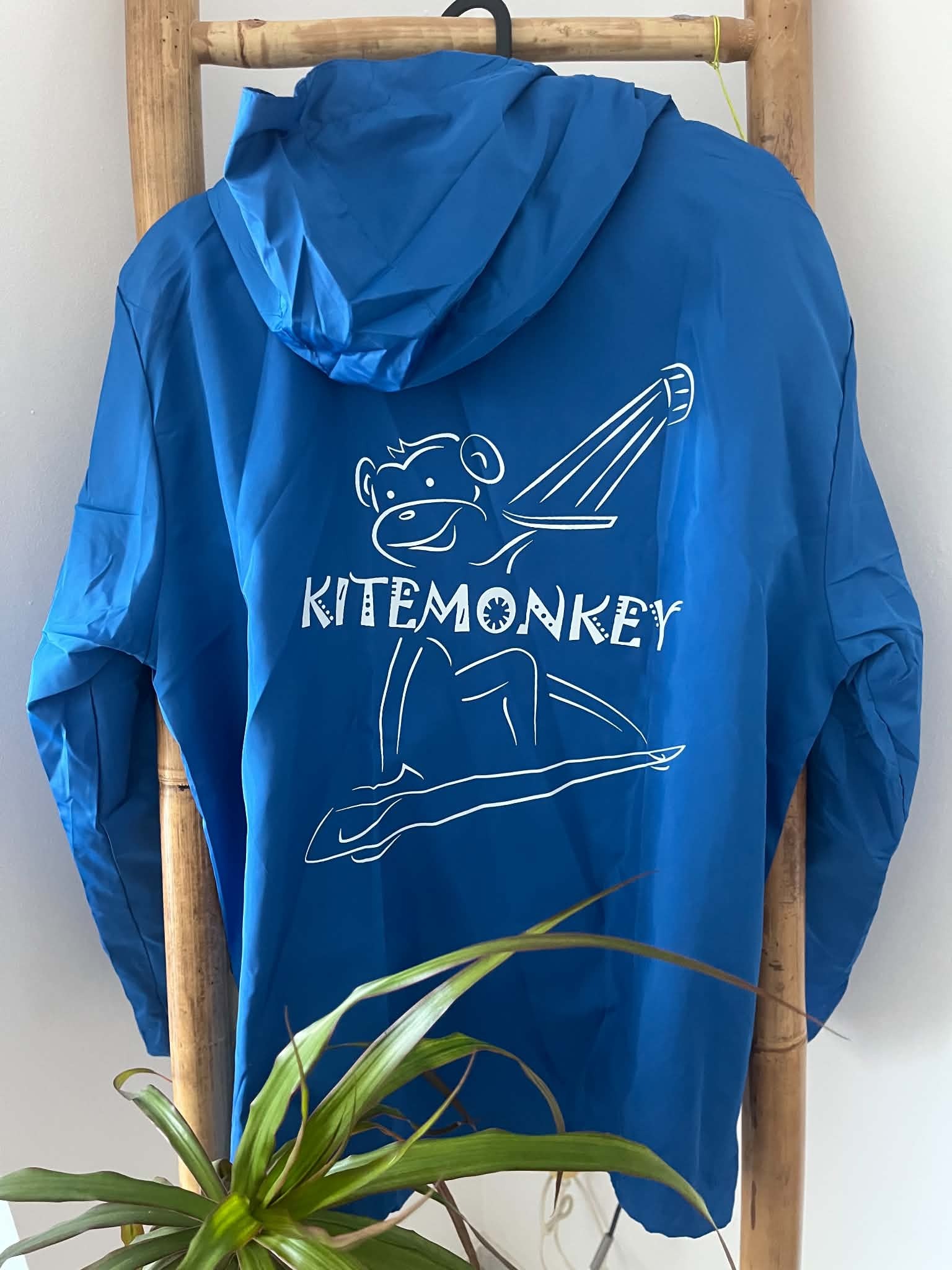 Electric blue Kitemonkey windproof jacket with hood and large kitesurf logo on the back