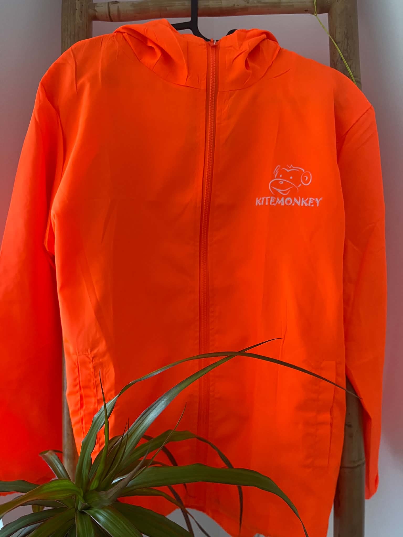 Orange Kitemonkey windproof jacket for kitesurfing, wingfoiling and watersports