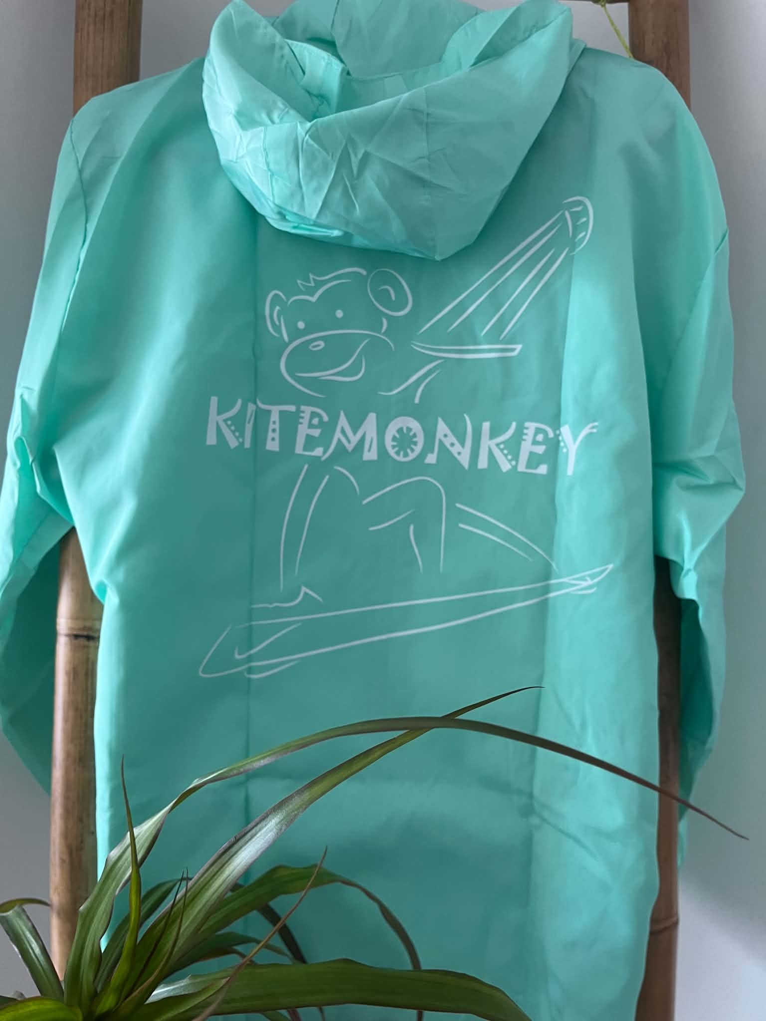 Turquoise Kitemonkey windproof watersports jacket designed to wear over a wetsuit